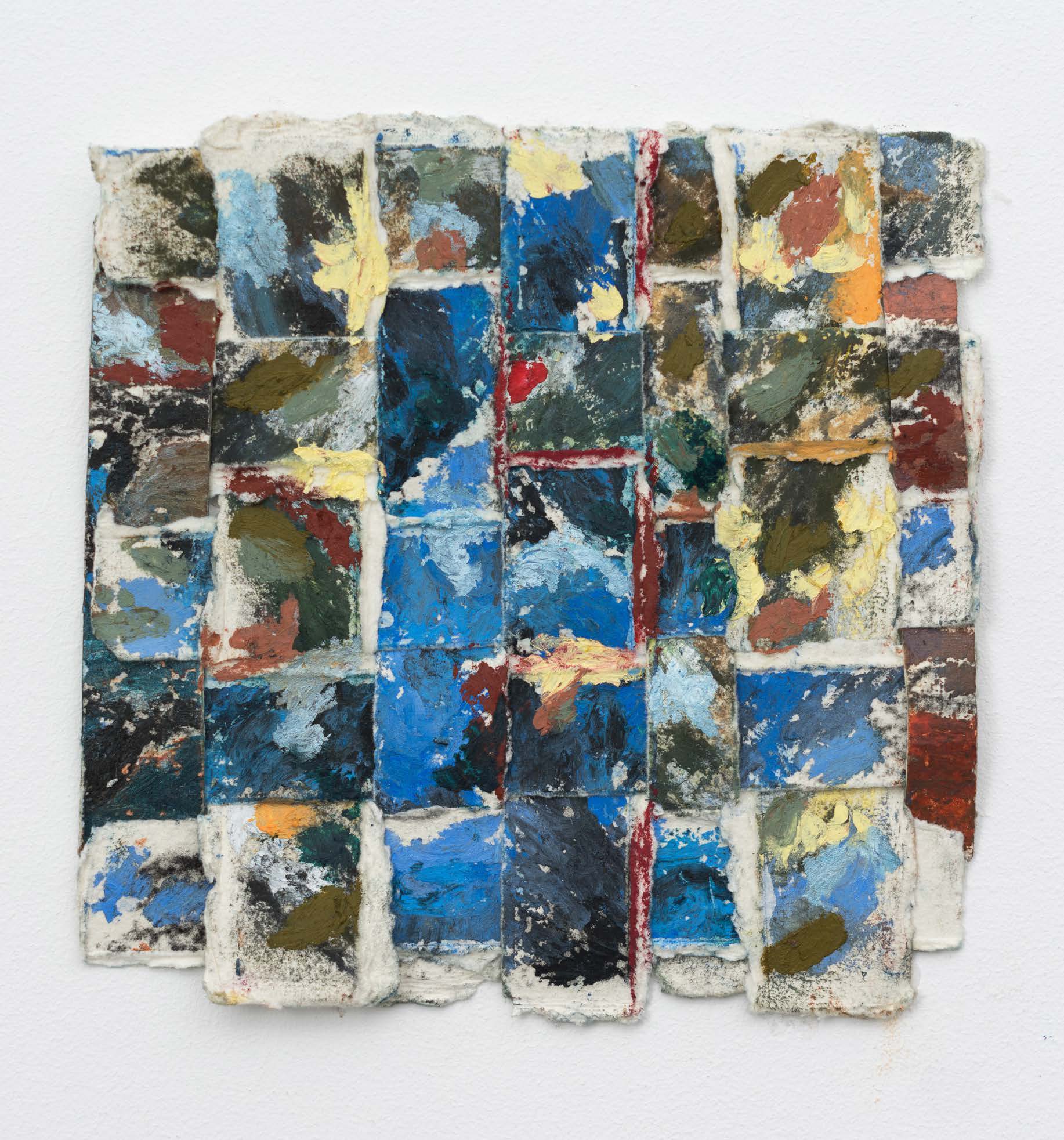 A square of woven paper in turquoise, cream, black and rust.