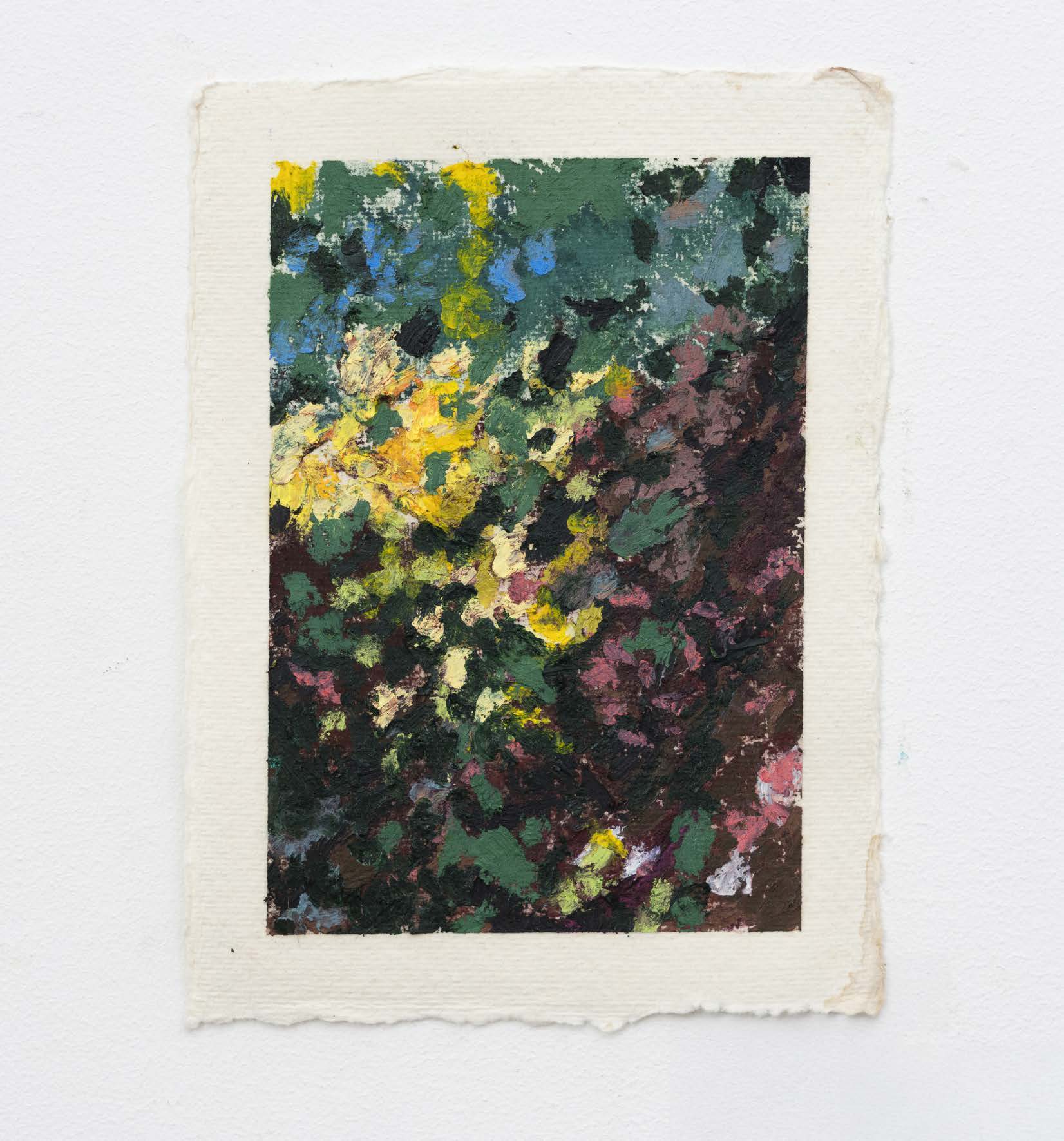 Dense black, yellow, blue and green marks on a small sheet of paper.