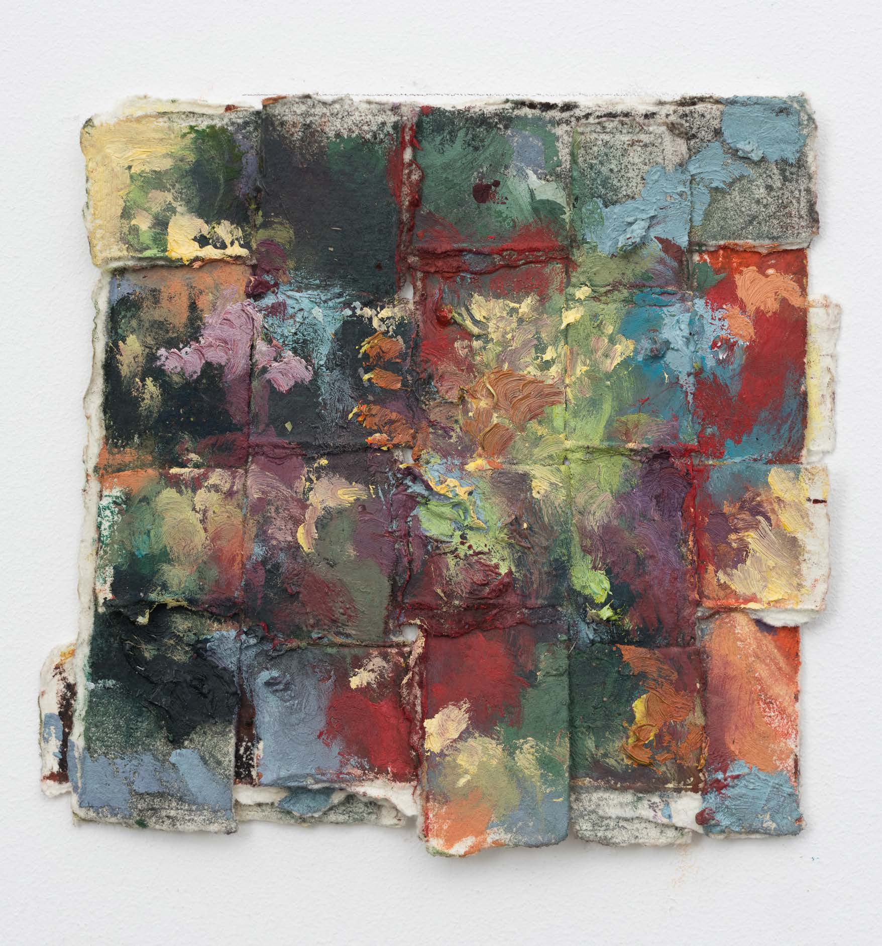 A small square of woven paper with muted green, blue, red and ochre marks.