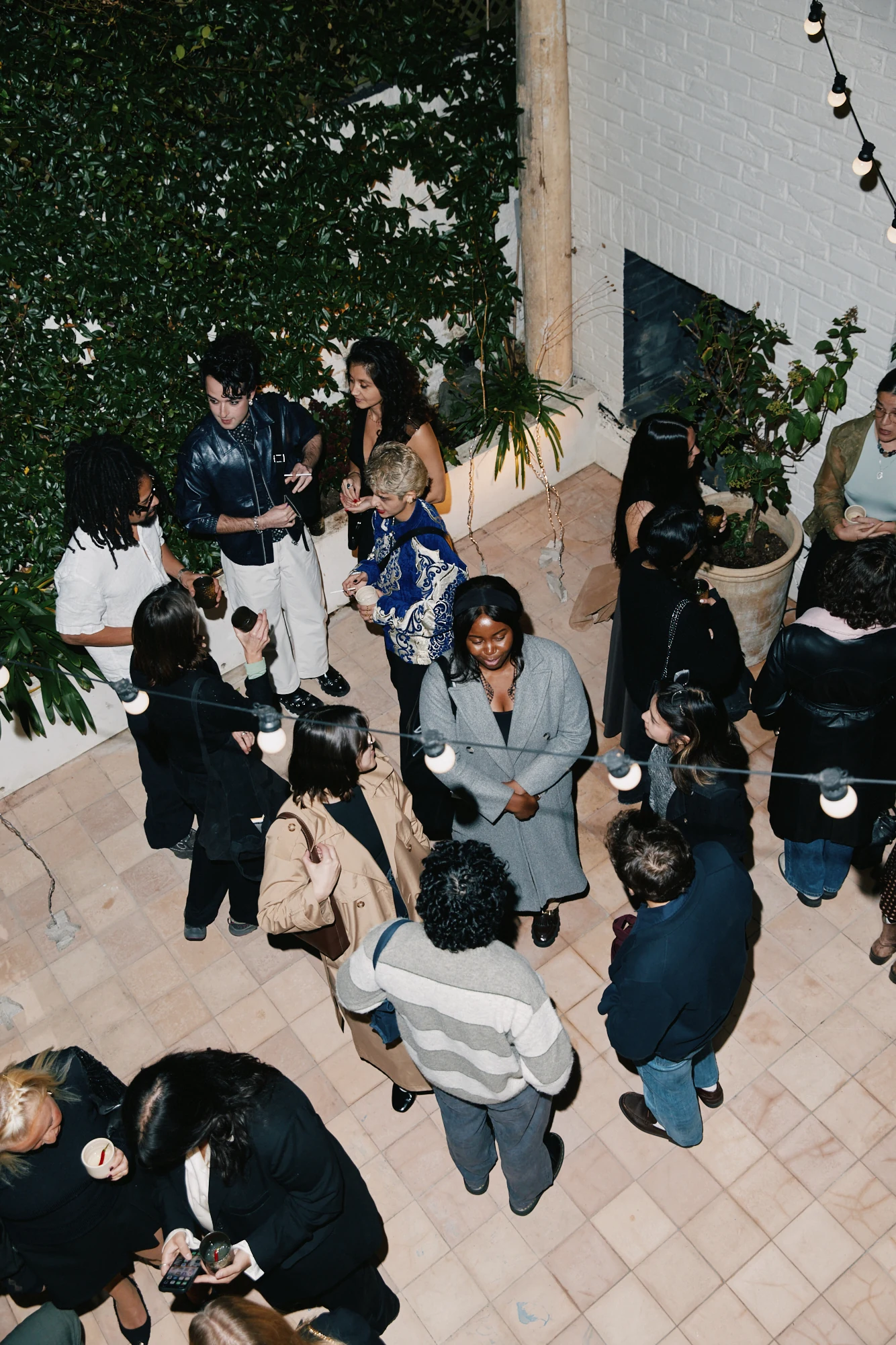 Guests gathered in the walled garden, viewed from above.