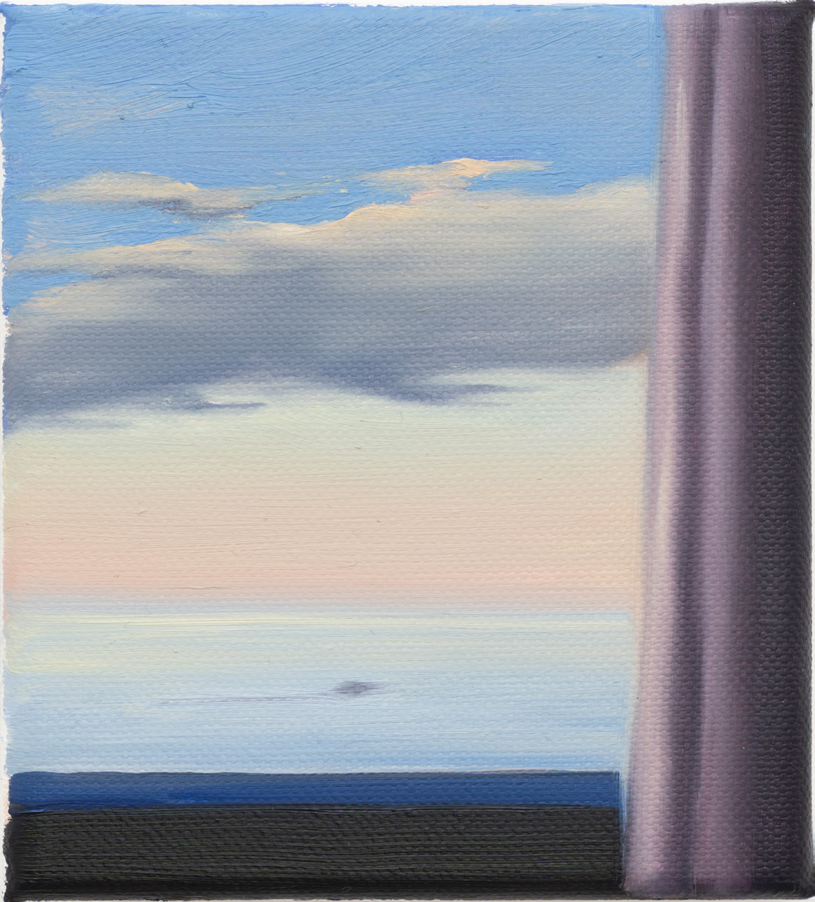 A sea horizon seen beside a pale curtain and a dark windowsill.