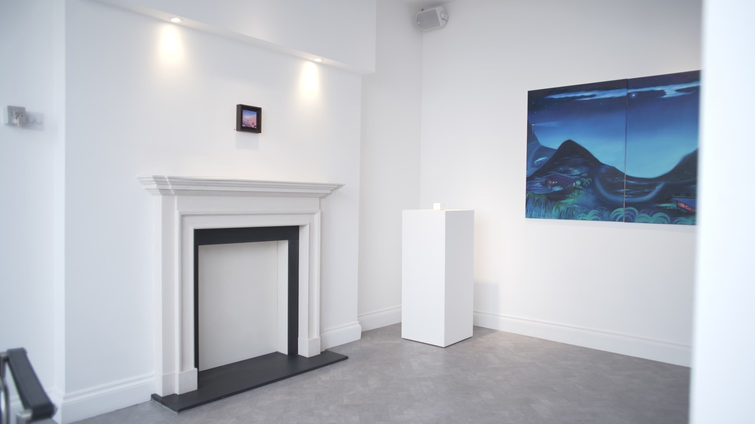 Installation view of These Walls That Protect Us: paintings around a white fireplace and a large blue landscape on the right wall.
