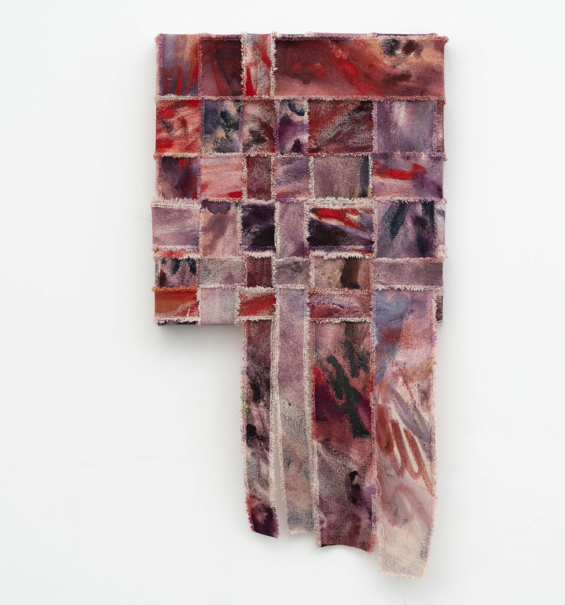 A red and pink woven canvas with long strips hanging from its lower edge.