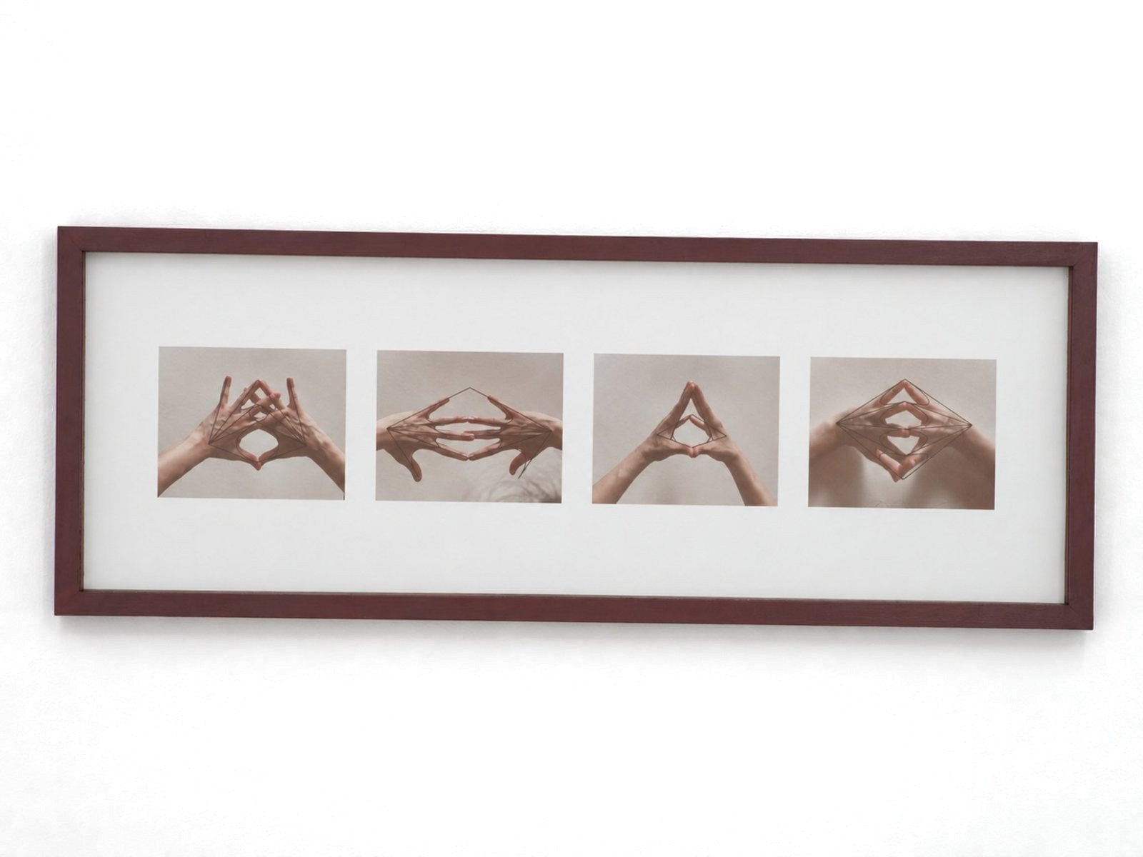 Four photographs of hands making diamond and triangle shapes, in a long red frame.