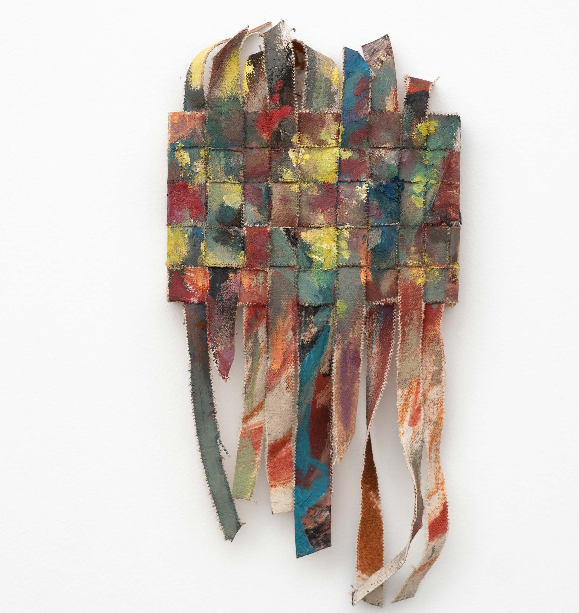 A narrow multicoloured woven canvas with long curled strips hanging below.