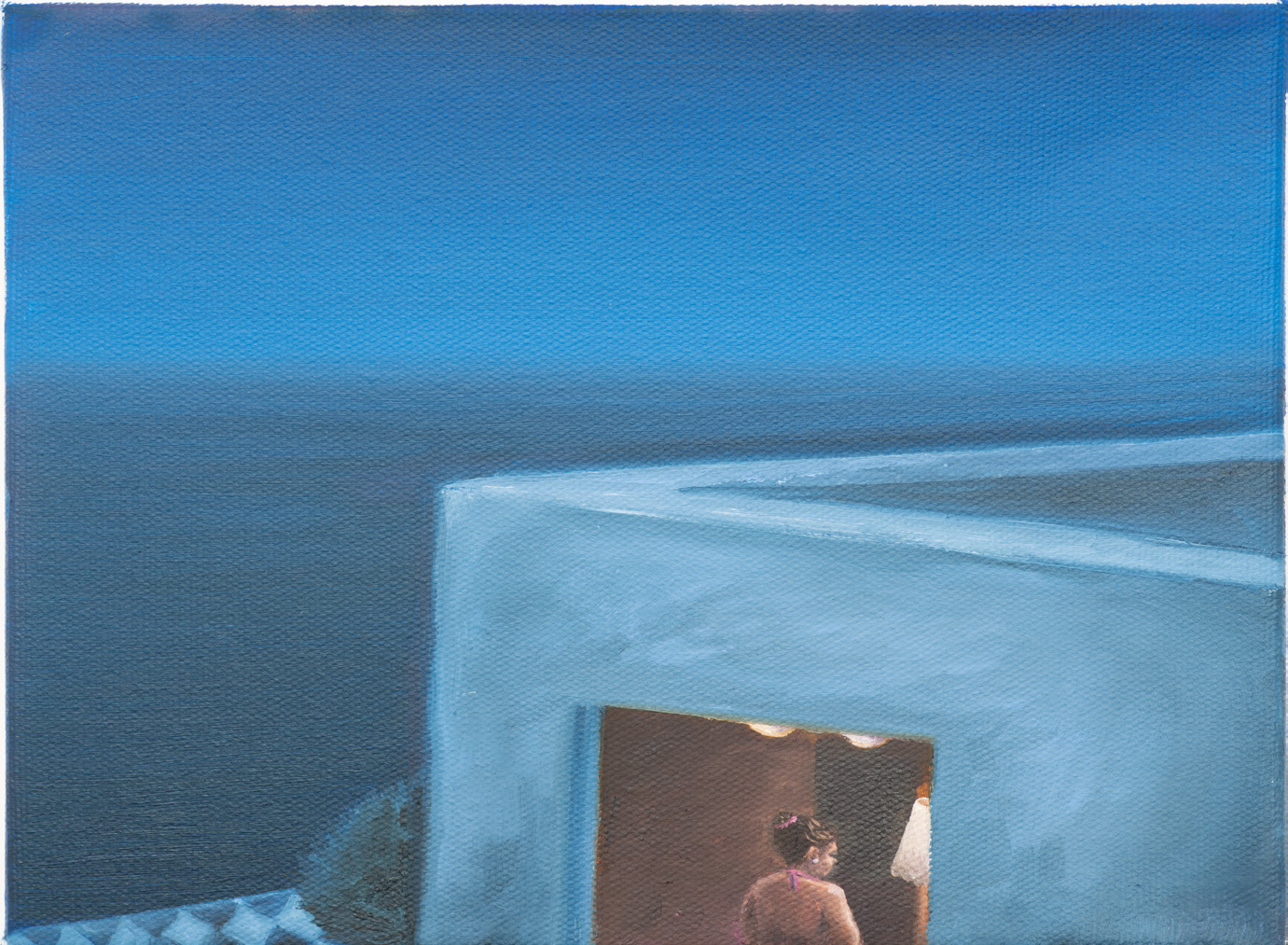 A blue sea and white wall with a small view into a room below.