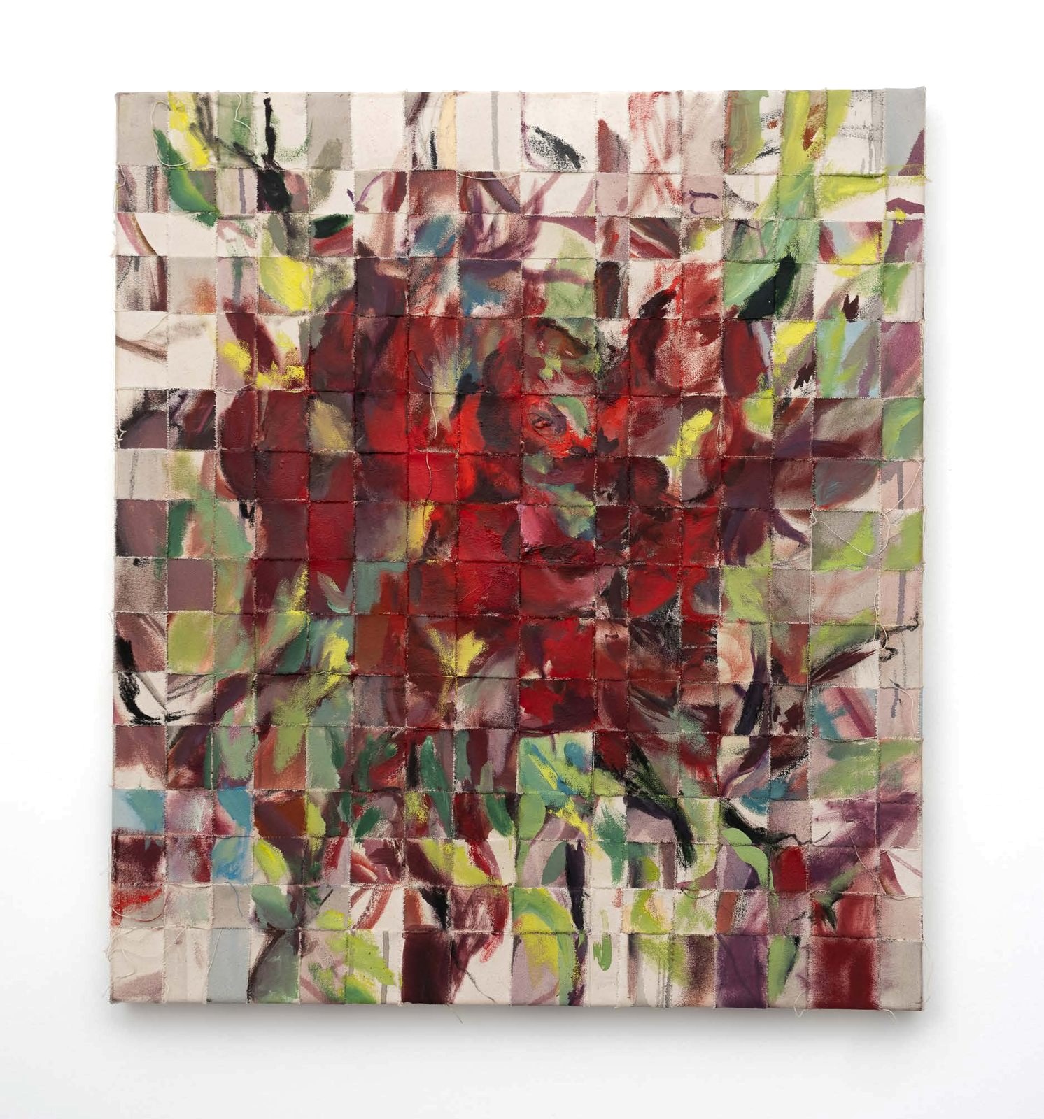 A woven painted canvas in deep reds and greens.